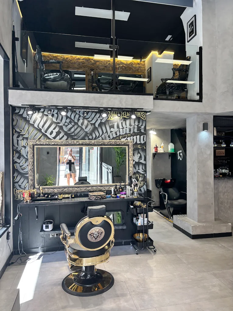 Puesto de barbero con espejo ornamentado y mural caligráfico